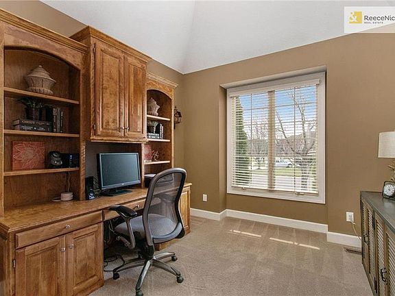 Enjoy the privacy of a first floor office with 11' vaulted ceiling and custom built-in desk.