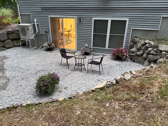 Private outdoor patio with lights on in the apartment