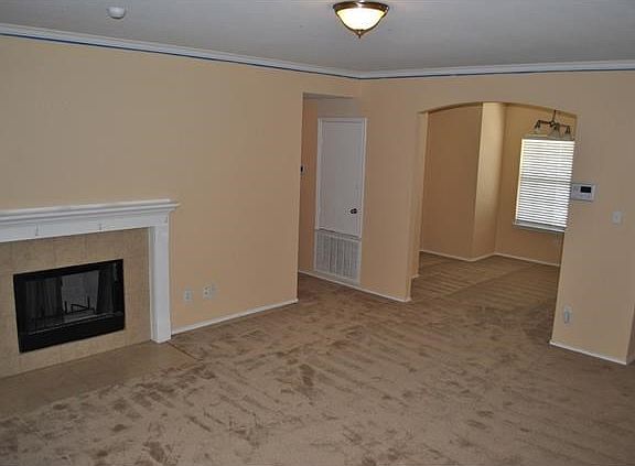 Living room with crown molding and fireplace
