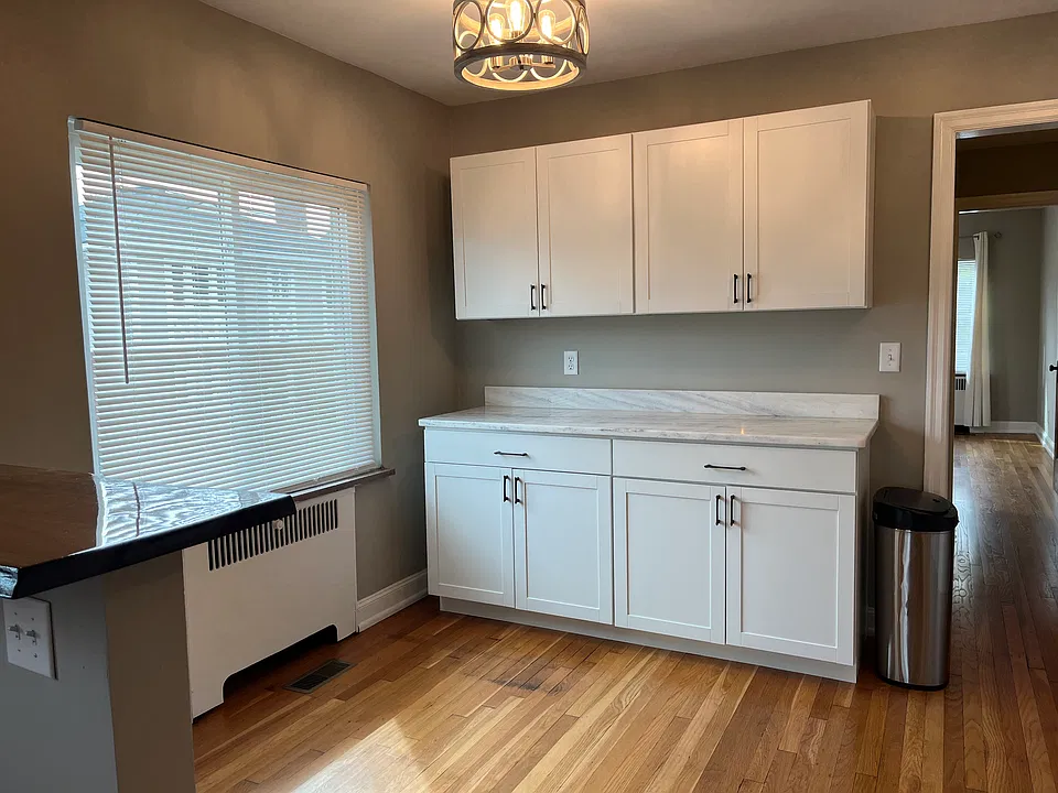 Updated kitchen cabinetry and lighting. Mini-blinds are new throughout.