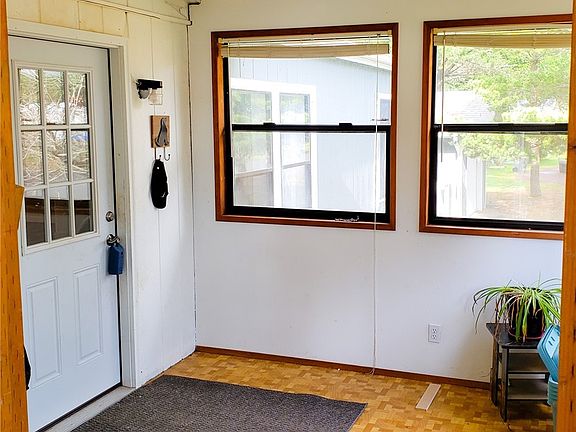 Secure covered sun porch leading to front entry