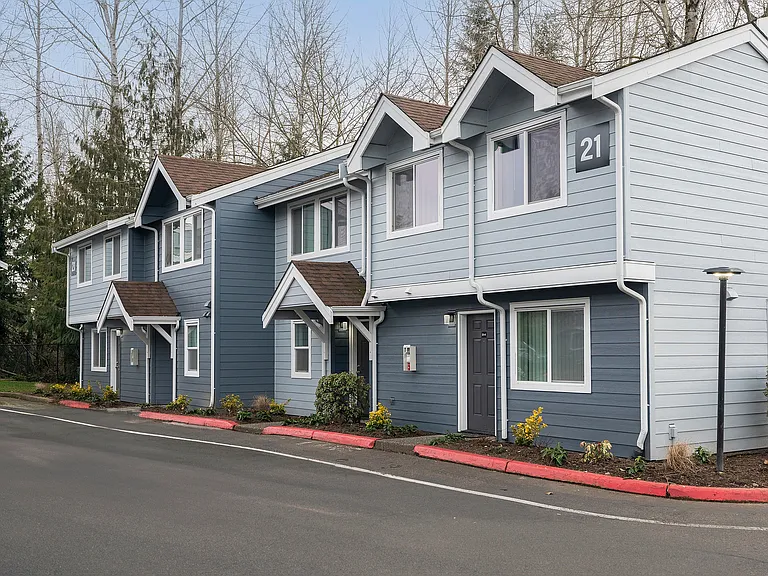 Explore the inviting facade of this charming townhouse, perfect for those seeking a peaceful neighborhood vibe.