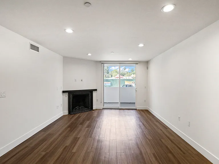 Living Room with Electric Fireplace, Recessed Lighting, Vinyl Flooring, and Patio