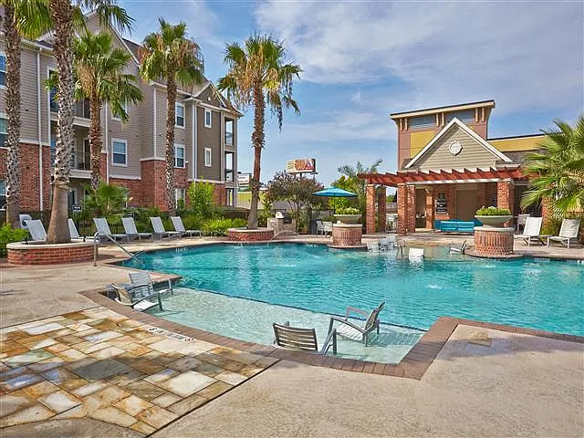 Pool with sundeck and poolside seating