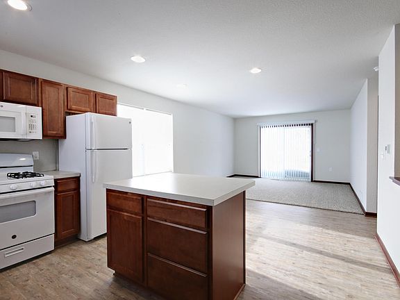 Entryway, facing kitchen, dining, and living room.