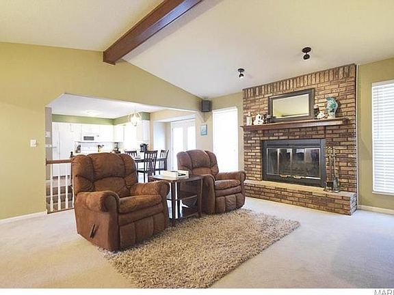 Great Room with vaulted ceiling & wood beam