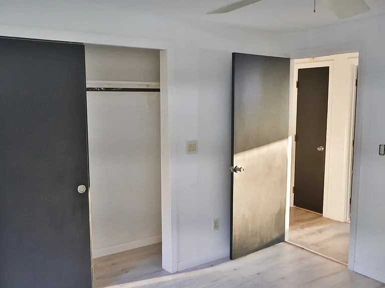 Bedroom 1 _ Fully Renovated with Freshly Painted Walls and Doors, Plus Brand-New Flooring Throughout.