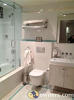 Downstairs bathroom with full glass enclosed bath / shower