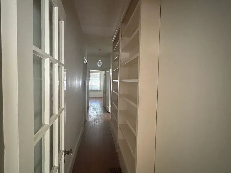 hallway with built in bookshelves