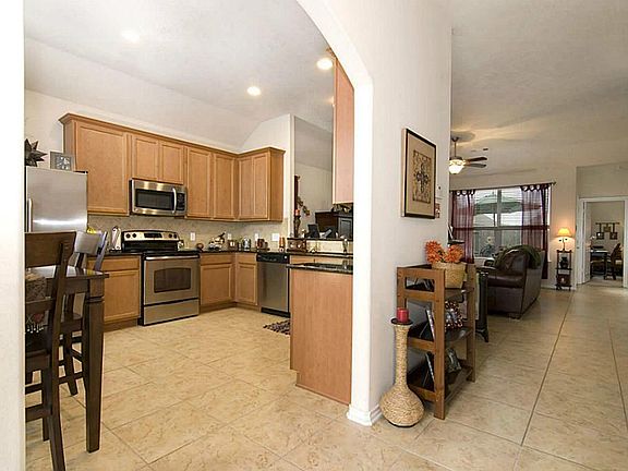 A large arched opening allows access to the great kitchen. While the tile flooring also extends past the kitchen and into the family room.