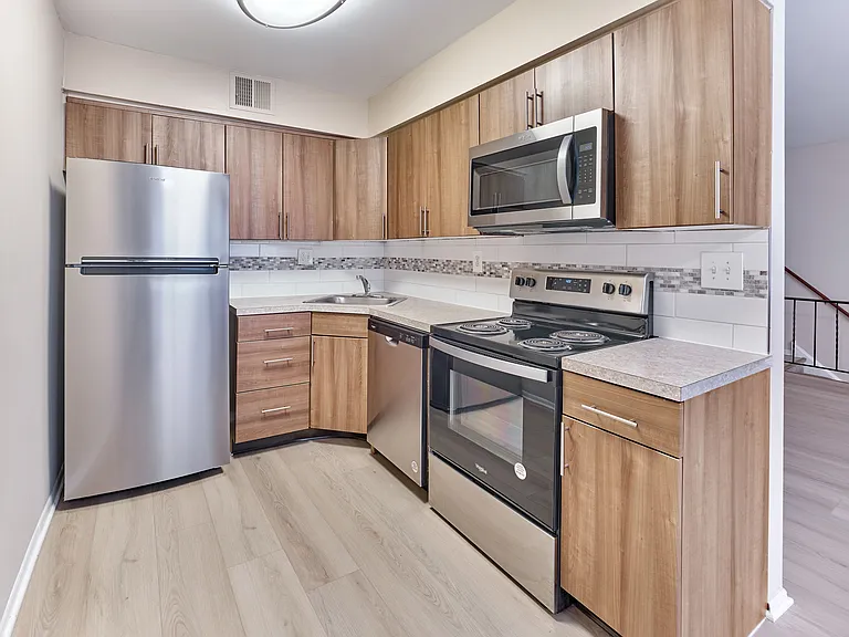 Sleek stainless steel appliances and modern finishes in the upgraded kitchens at Maple Grand Apartments, Maple Shade, NJ.