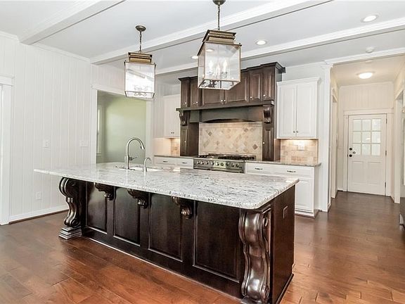 Kitchen with custom cabinetry and commercial appliances 