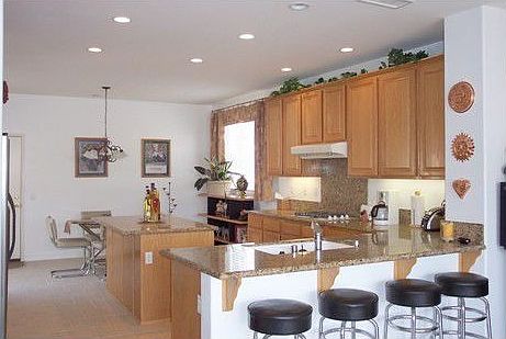 granite counter tops, center island, recess lighting, oak cabinets