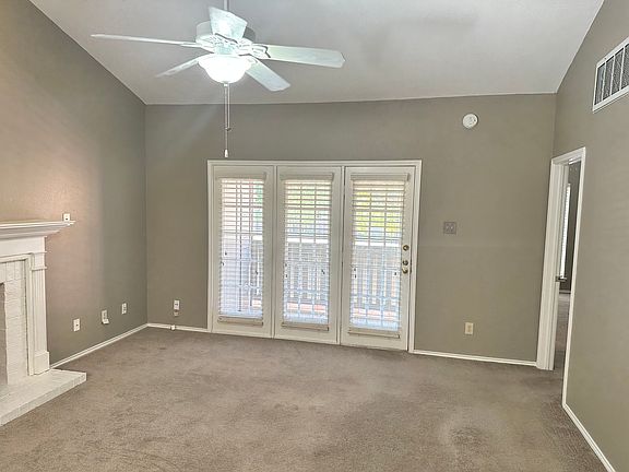 Large living room with wood burning fireplace, vaulted ceilings and balcony. Master bed room through the door on the right.