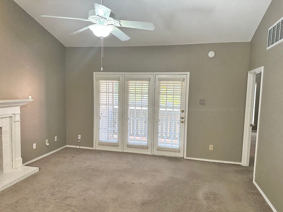 Large living room with wood burning fireplace, vaulted ceilings and balcony. Master bed room through the door on the right.