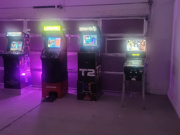 Versatile garage/game room with ample open floor space, ideal for a recreation setup or additional storage.