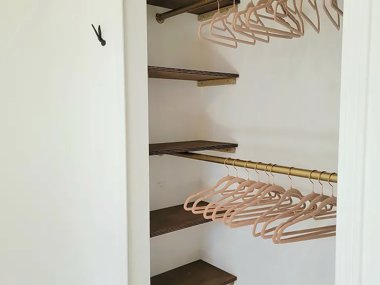 Walk-in closet with generous shelving and hanging space.
