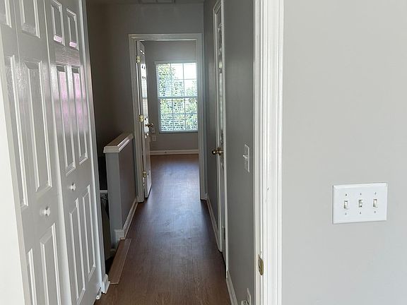 Hallway between bedrooms, with the washer and dyer in the middle