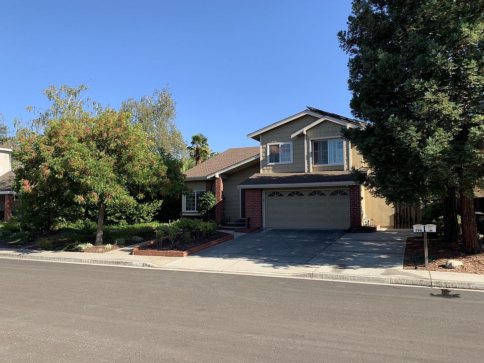Fully landscaped yard with two car garage