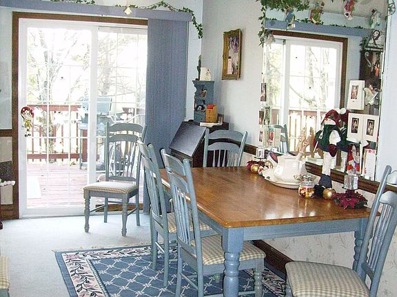 Bright Dining Room w. Double Patio Doors opens to Deck.
