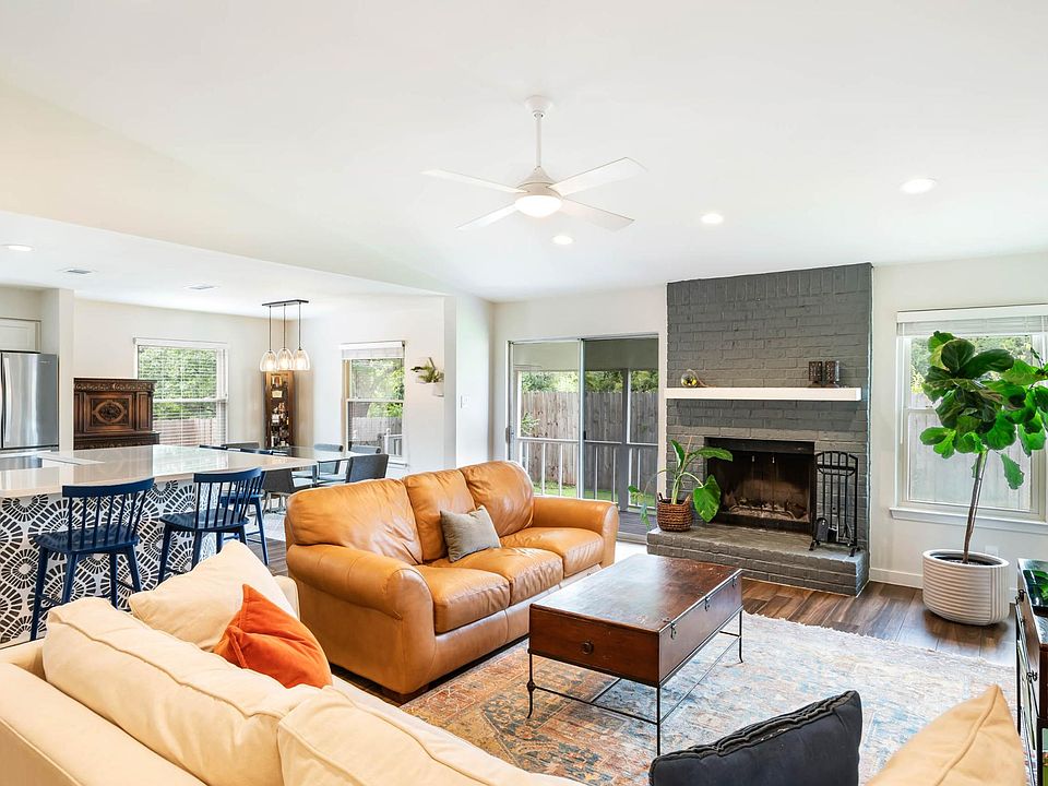 Open floor plan with connected living room, dining, and kitchen areas.