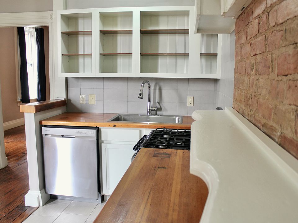 Countertops were handmade using wood salvaged from the renovation of this building in 2014. Stainless steel gas stove and dishwasher.