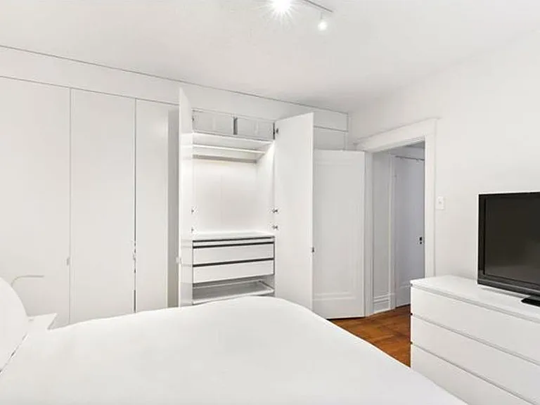 bedroom 1 with custom built in shelves