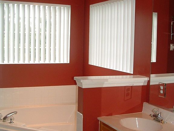 Double sink vanity, separate shower, and jacuzzi tub.