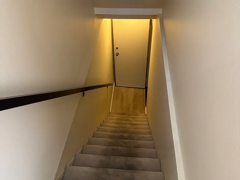 Stairs from private garage up to first living floor