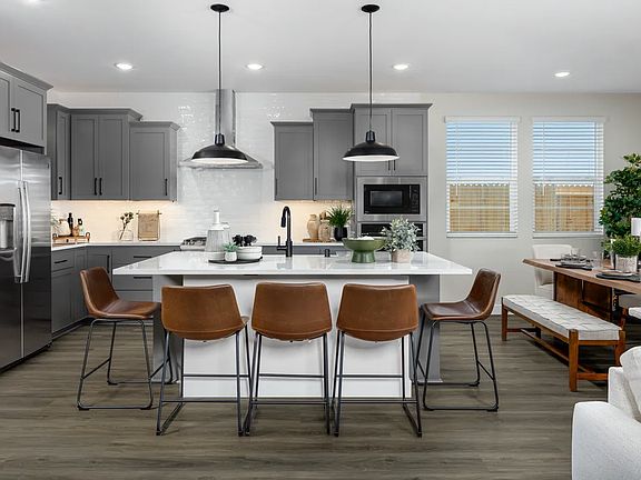 Kitchen with pendant lighting and floating shelves