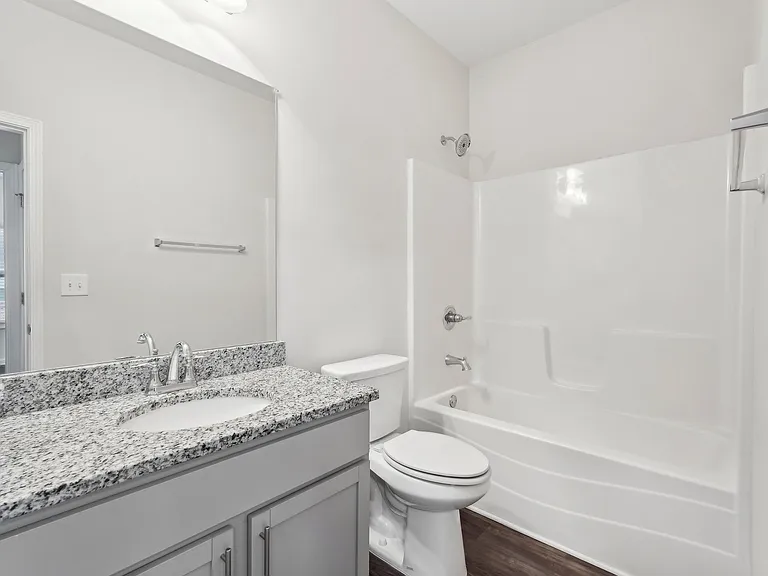 Secondary Bathroom with single vanity with a tub and shower combo.