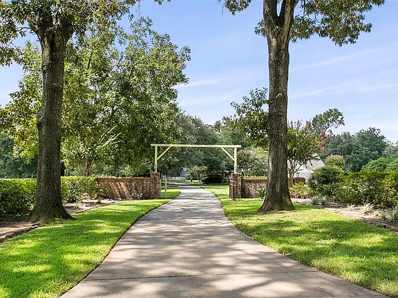 Long driveway and beautiful trees lead to the home with a 3 car garage that has built-ins, new openers, 2 closets and built-in storage with peg board.