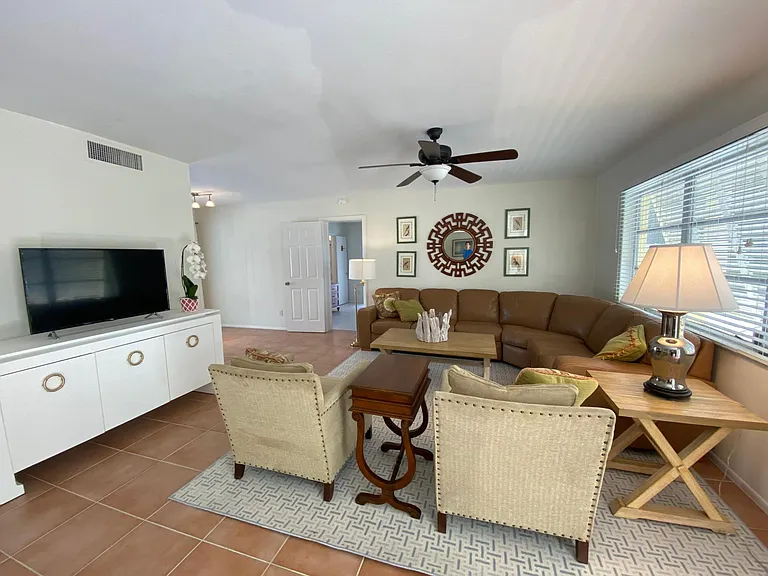 Living area with large leather sectional, Lounge seating, LCD TV and wireless internet.