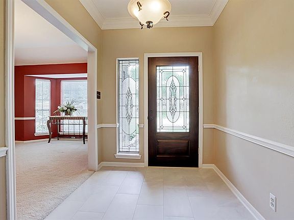 Solid wood door with glass inlay and sidelight keeps entry into the home nice and bright. Tile floor was replaced in 2018.