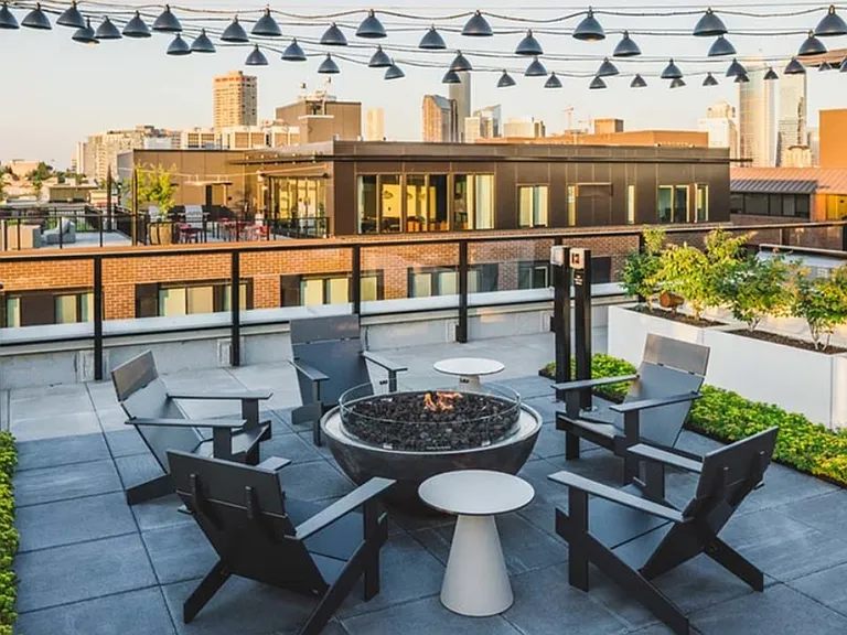 Enjoy the city while sitting around a firepit under twinkling lights at Modera Broadway