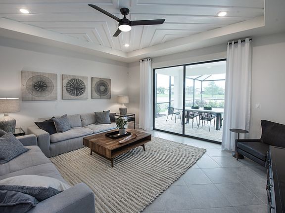 Model Representation Gathering room with sliding glass doors to the covered lanai extended screen