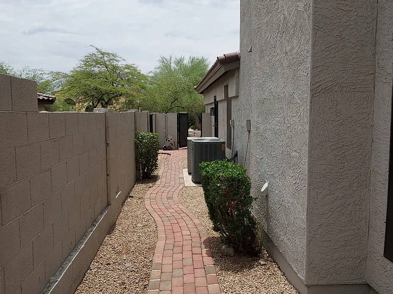 Gated side yard. 360 degrees fenced with a locked gate for added security and ring door below camara