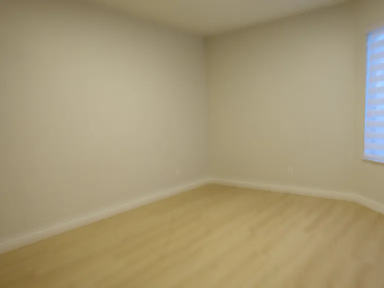 Bedroom #1: Large window with view of patio. Cordless cloth blind and filtered light. Oak floors and oak ceiling light