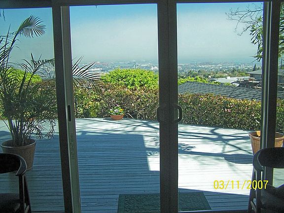 wall of windows and access to deck with views that goes off of family room