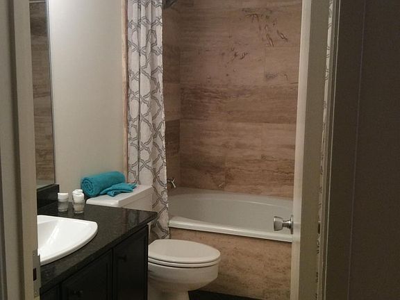 Roomy oval tub/shower combo with gorgeous tile.