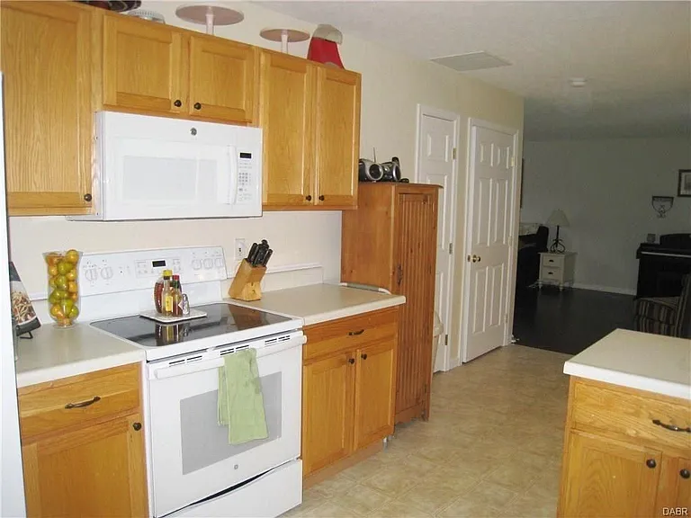 Standing in the kitchen looking back towards the living room. Refrigerator (not pictured) is to the left in this photo.