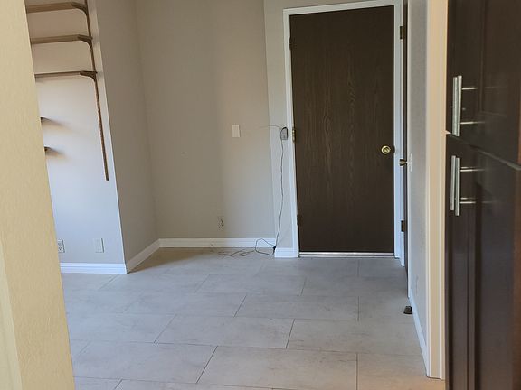 2nd Living area/den off the kitchen, with pantry on the right and view of door to the garage.
