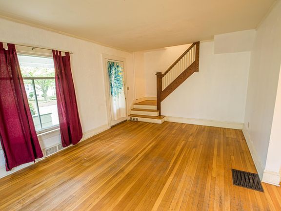 Large living with lots of light. Oak floors. Archway leading to dining room. 18.2' x 12.0' . Walls are light gold tone.