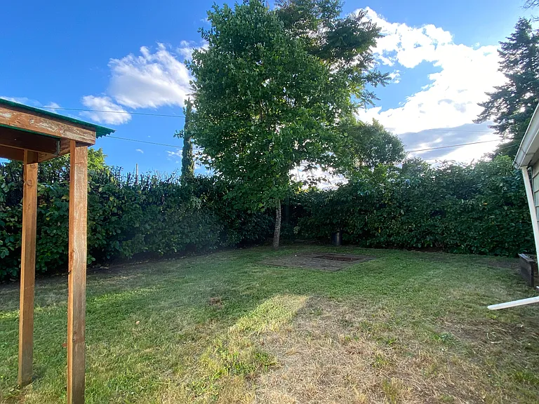 Large, private, fenced backyard with good light for gardening and fire pit/ patio