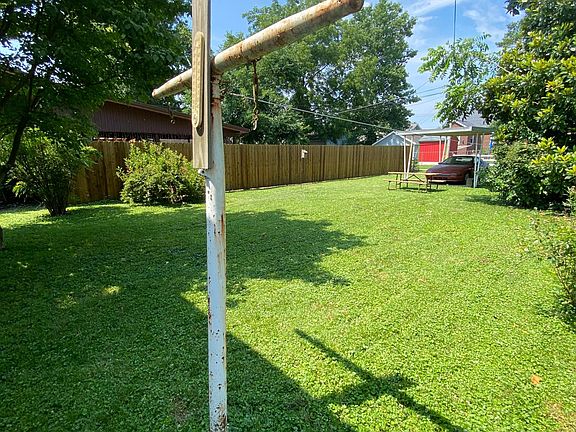 Back yard with covered car port