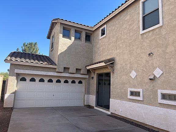 Exterior of home showing 2-car garage and long driveway
