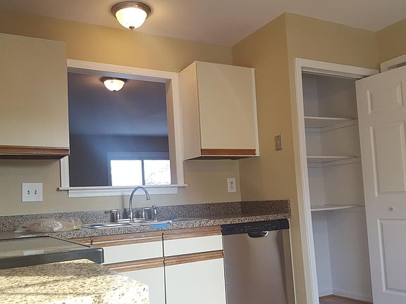 Kitchen looks out to living room with breakfast bar