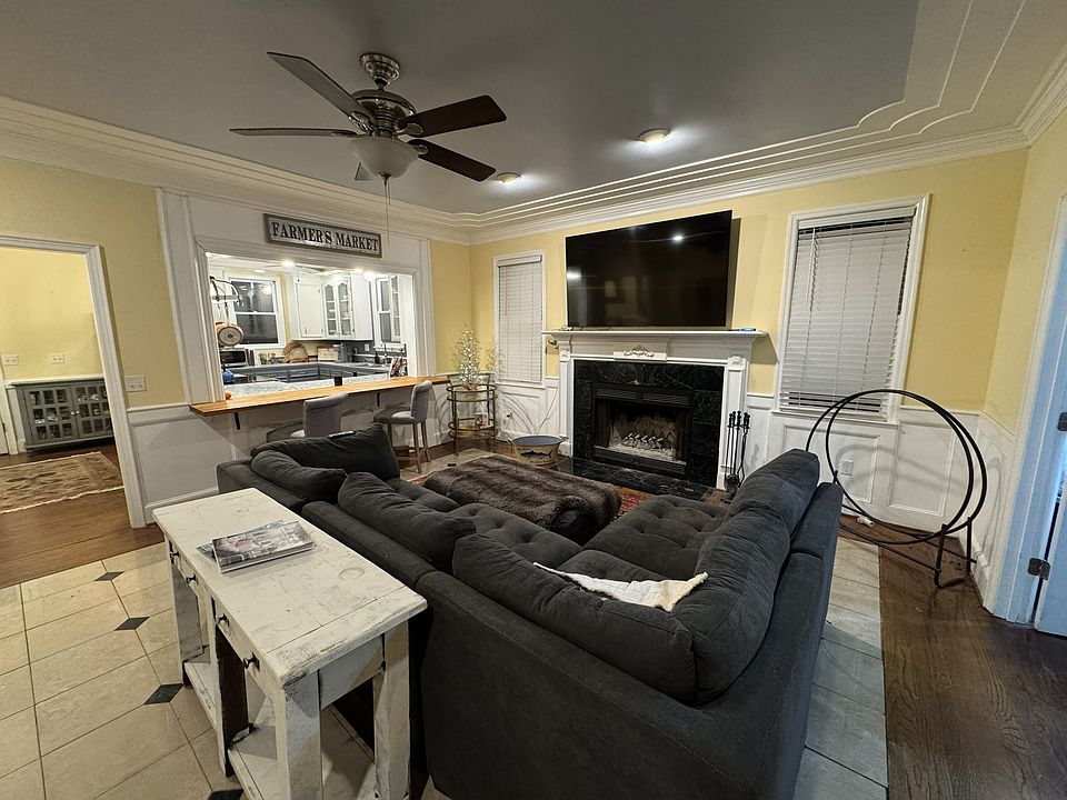 Family room with wood burning fireplace and opening to kicthe with bar seating