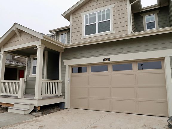 2 car garage with parking pad.