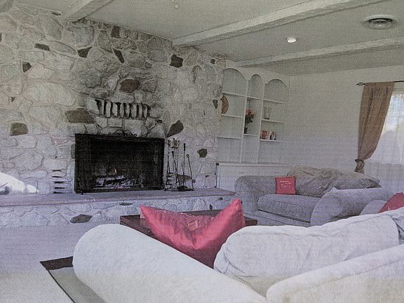 Additional view of living room with large fireplace